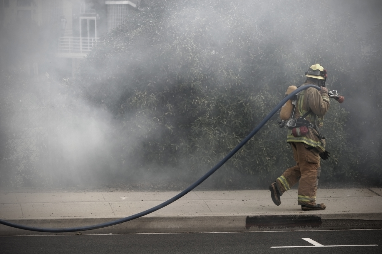 firefighter walking through smoke