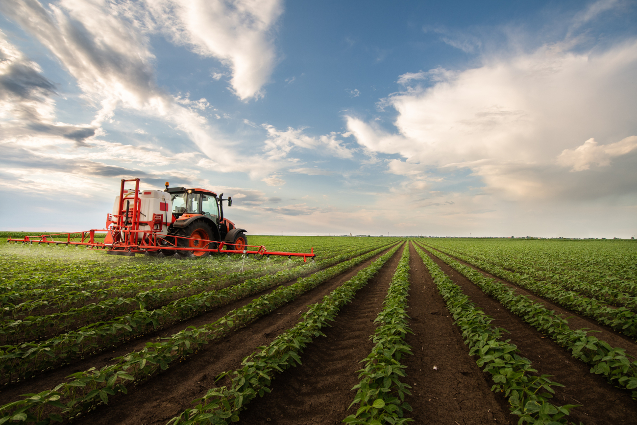 tractor spraying crops with pesticides