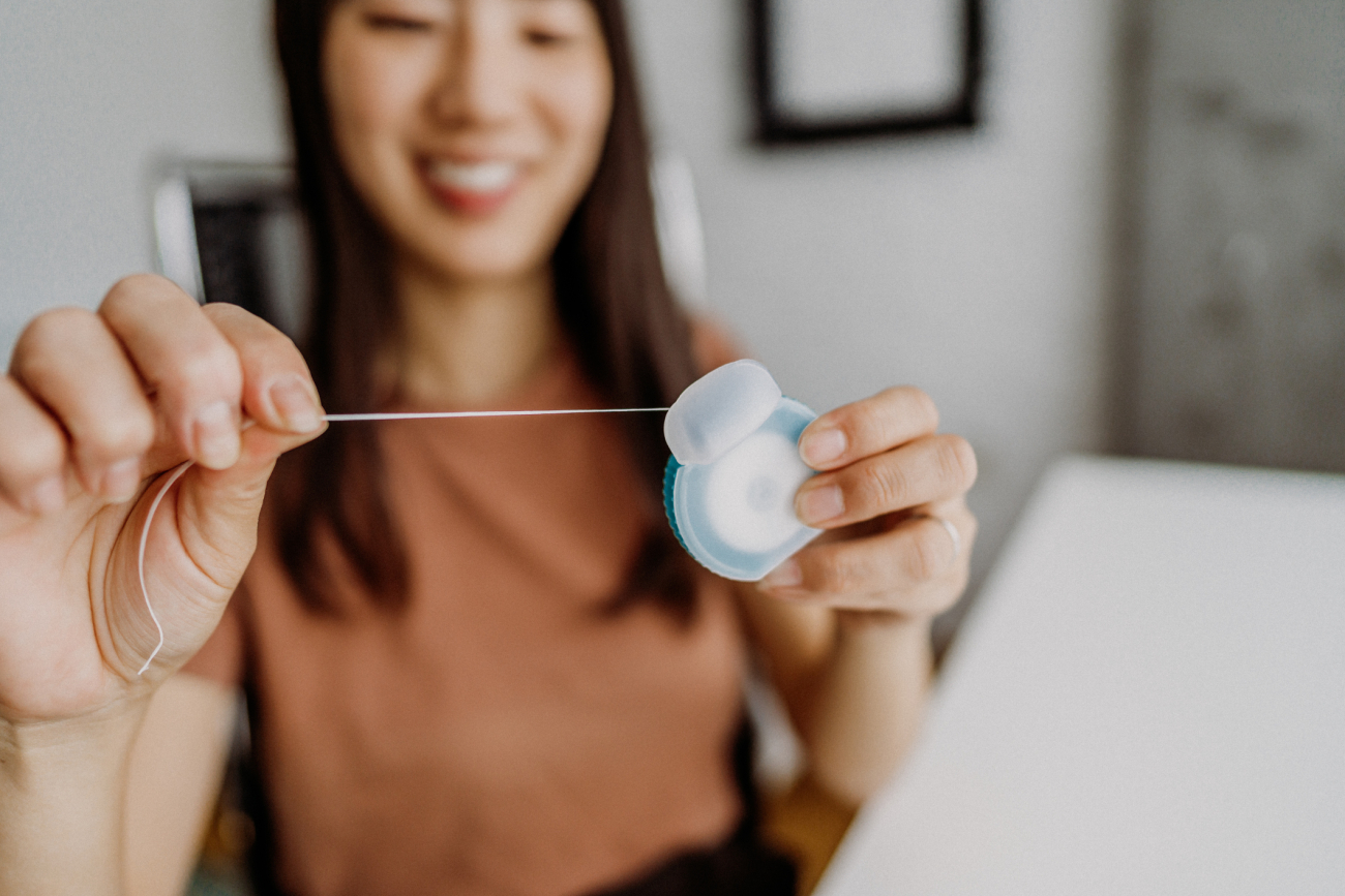 woman holding dental floss