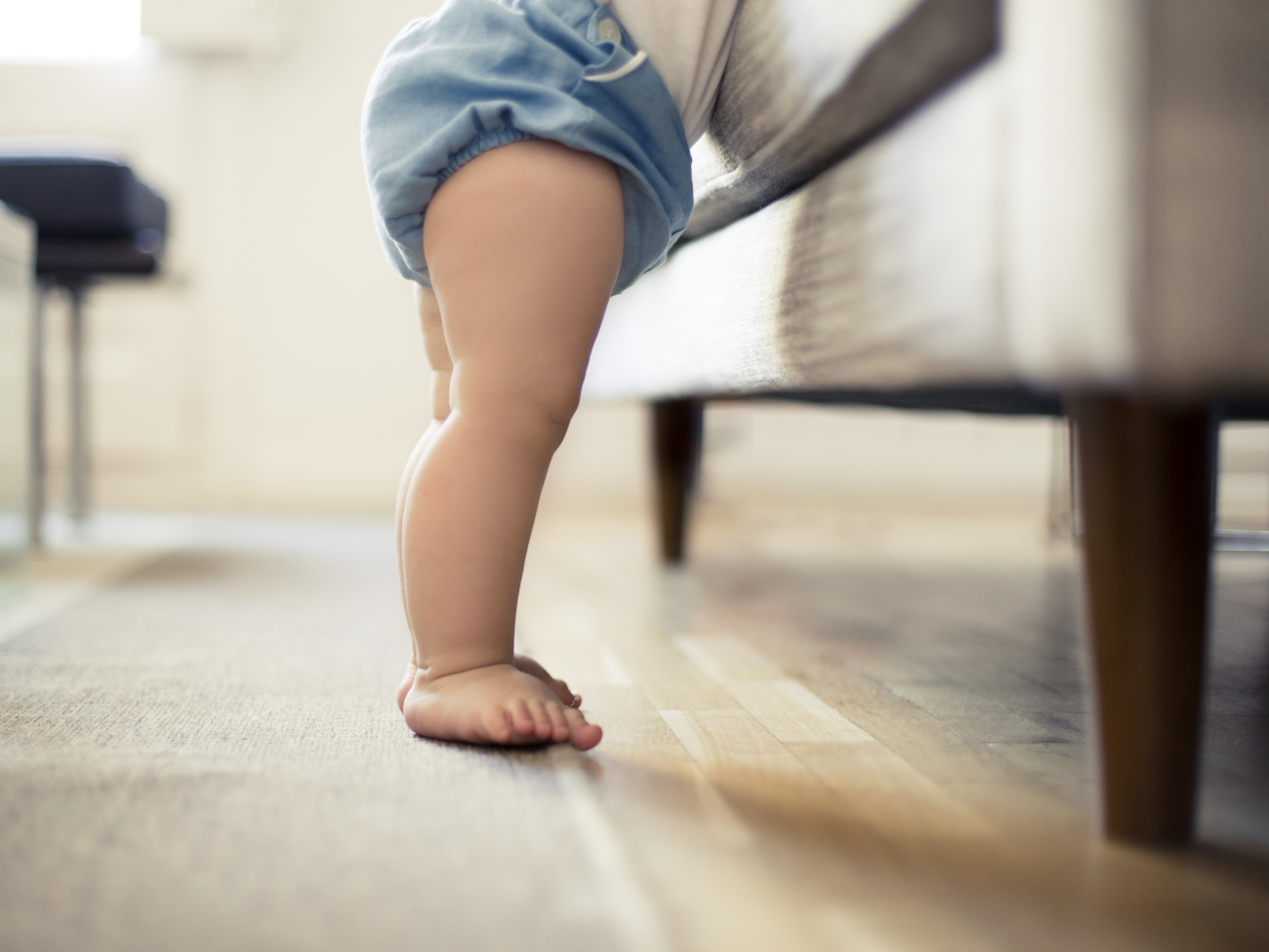 toddler next to couch