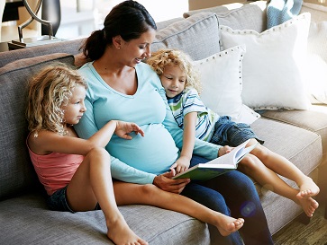 mother on couch with daughters