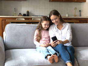 mother and daughter looking at smartphone