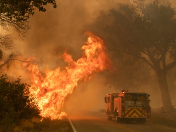 firetruck driving toward brush fire