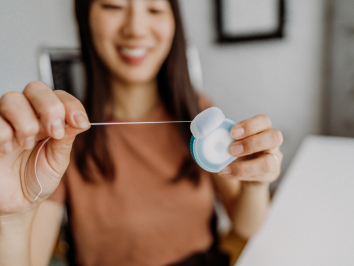 woman holding dental floss
