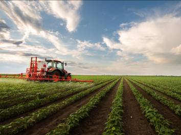 tractor spraying pesticides on crops