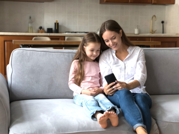mother and daughter looking at smartphone